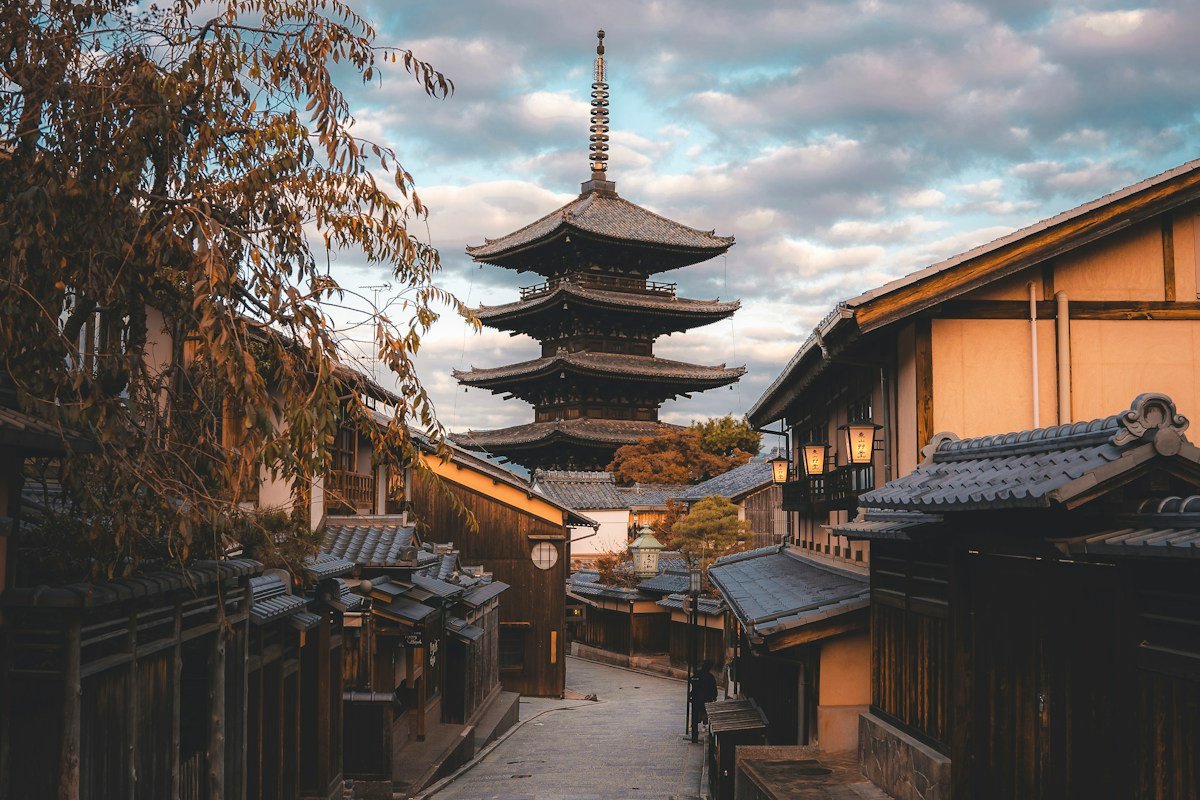 A narrow Kyoto street with traditional buildings and a pagoda