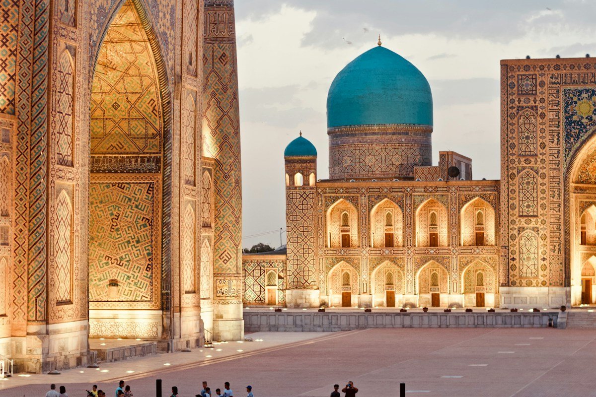 Decorative tiled architecture and a dome at the Registan in Samarkand
