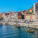 Traditional boats on the Douro beneath the colourful buildings of Porto