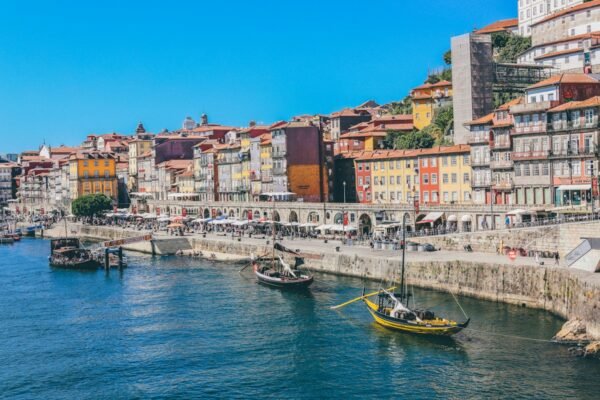 Traditional boats on the Douro beneath the colourful buildings of Porto