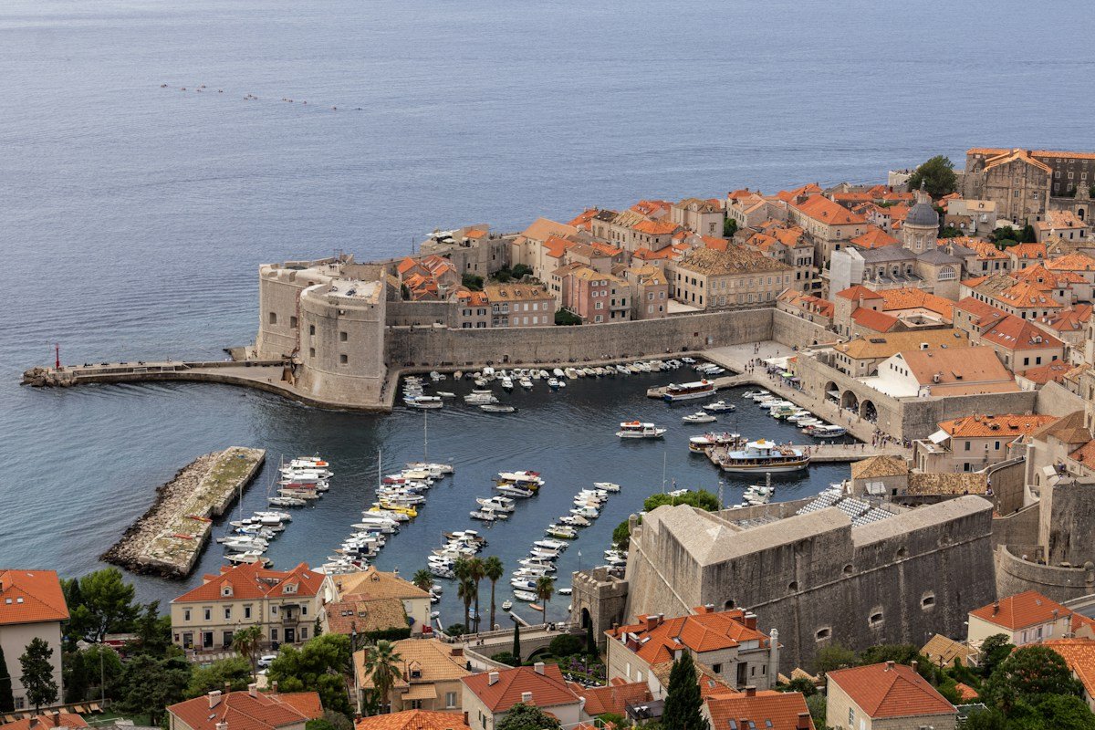 Dubrovnik old harbour with boats and stone buildings