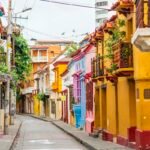 A narrow Cartagena street lined with colourful facades and balconies