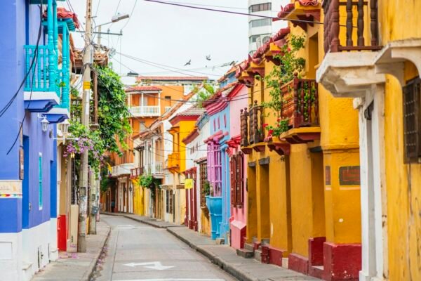 A narrow Cartagena street lined with colourful facades and balconies