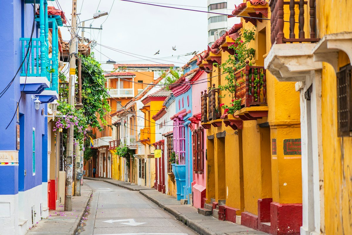 A narrow Cartagena street lined with colourful facades and balconies