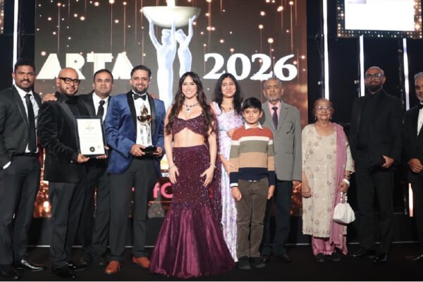 A group on stage with a trophy and certificate at the ARTA 2026 awards ceremony